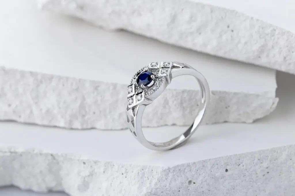 a silver ring with a blue stone
