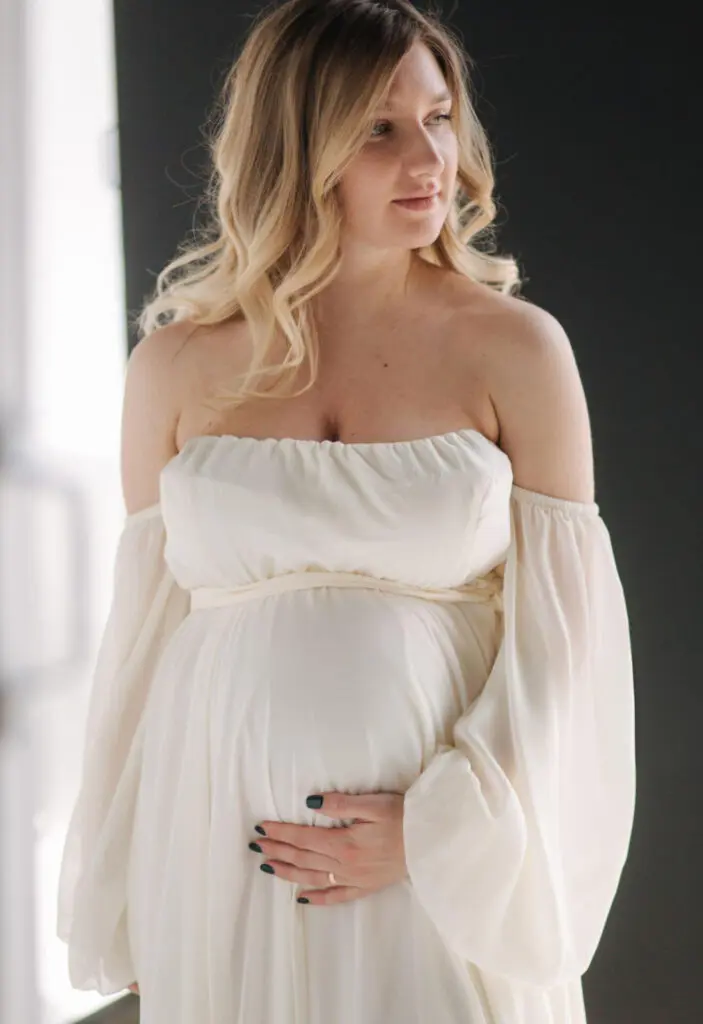 a pregnant woman in a white dress