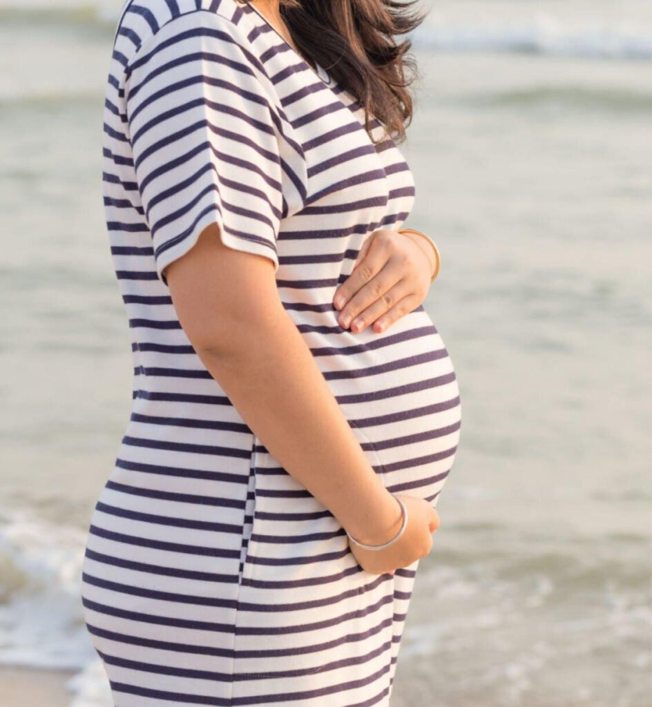 a pregnant woman holding her belly
